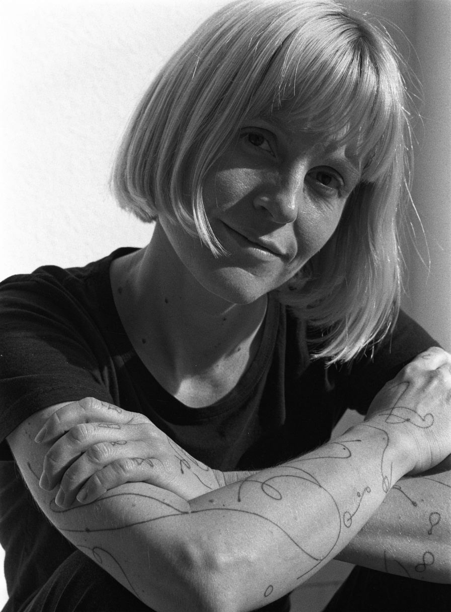 Ida, with fine-line flowers drawn down both forearms