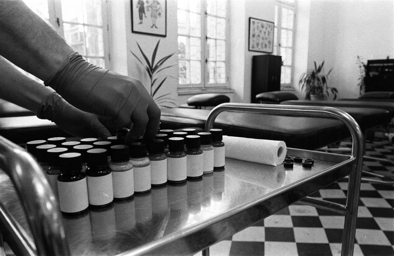 Gloved hands setting out ink bottles on a steel trolley